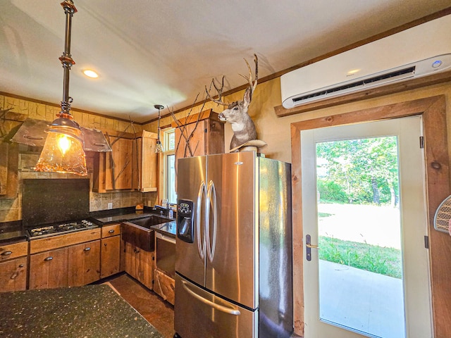 kitchen featuring sink, a wall mounted AC, decorative light fixtures, appliances with stainless steel finishes, and decorative backsplash