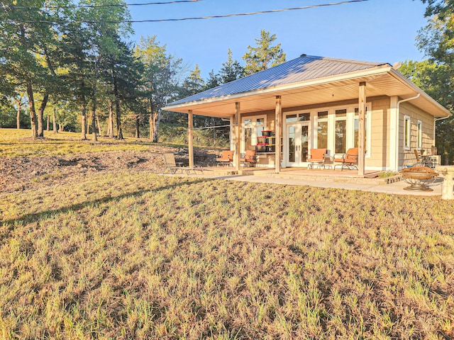 back of house featuring a patio and a yard