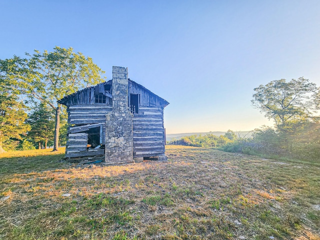 property exterior at dusk with an outdoor structure