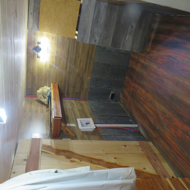 bathroom featuring hardwood / wood-style flooring and wood walls