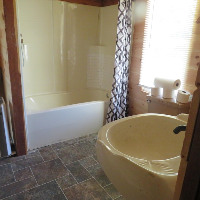 bathroom with shower / tub combo with curtain and radiator heating unit