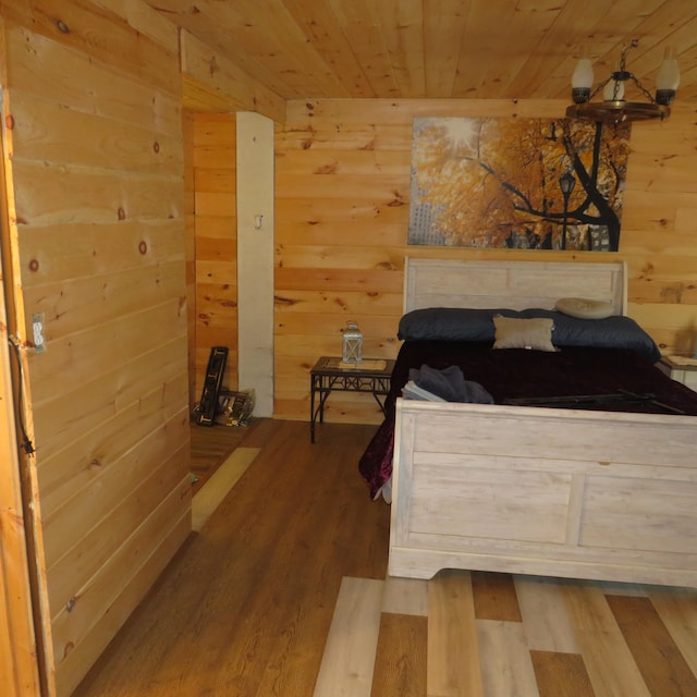 bedroom with hardwood / wood-style flooring, wood walls, and wood ceiling