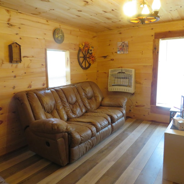 living room featuring heating unit, wood ceiling, wood walls, and hardwood / wood-style floors