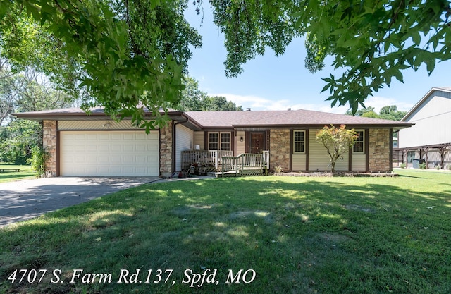 ranch-style home with a garage and a front yard