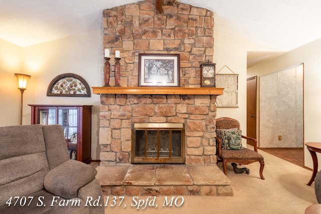 living room with a fireplace, vaulted ceiling, and hardwood / wood-style flooring