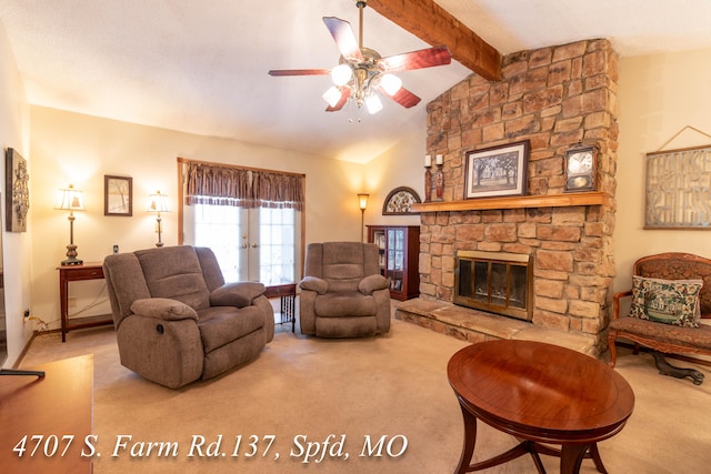 living room featuring carpet floors, vaulted ceiling with beams, a stone fireplace, and ceiling fan