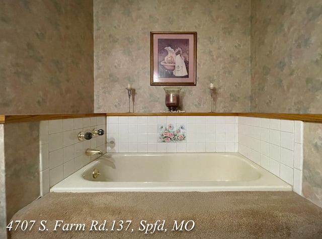 bathroom with a relaxing tiled tub