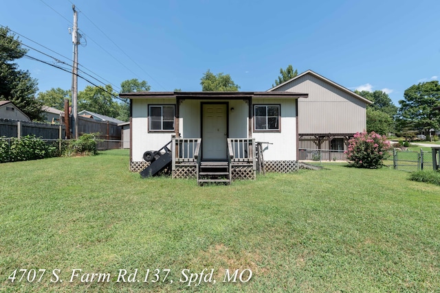 back of house with a lawn