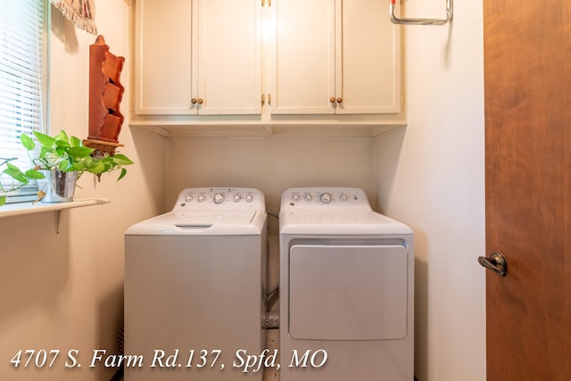 laundry area featuring cabinets and washing machine and clothes dryer