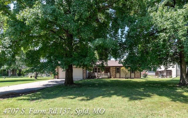 obstructed view of property featuring a front yard and a garage