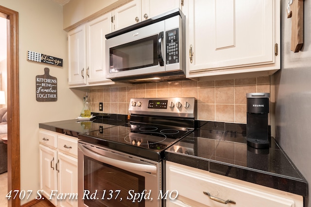 kitchen featuring tasteful backsplash, white cabinets, and appliances with stainless steel finishes