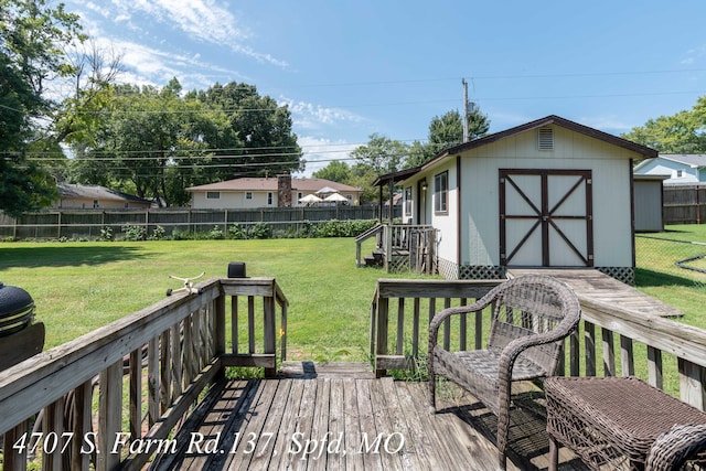 wooden terrace with a yard and a storage shed