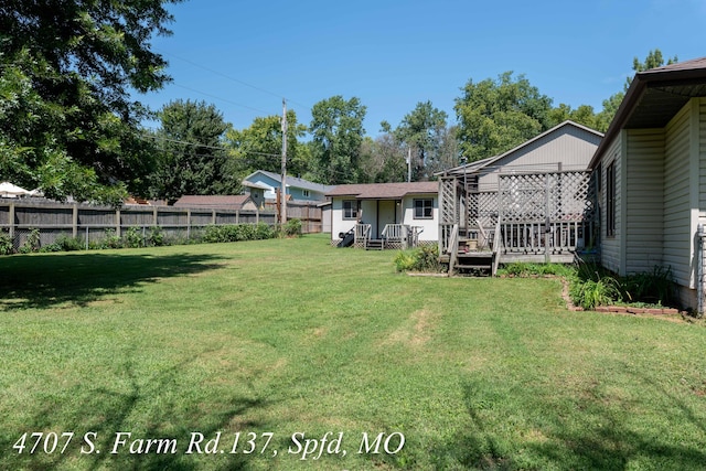 view of yard featuring a wooden deck