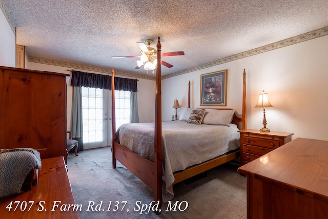 carpeted bedroom with access to exterior, a textured ceiling, and ceiling fan