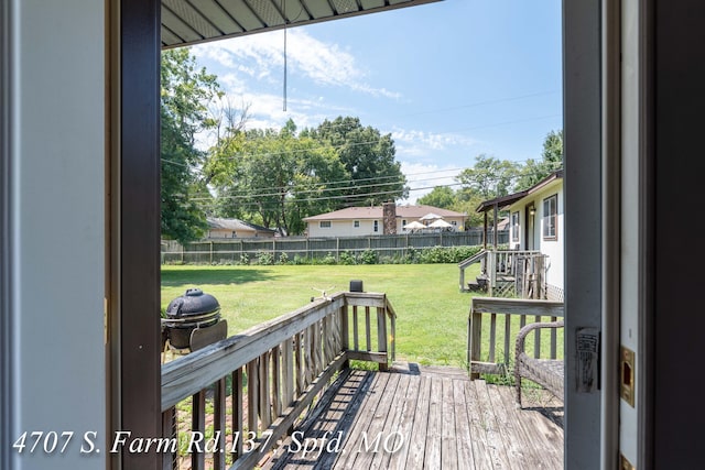 wooden deck with a lawn