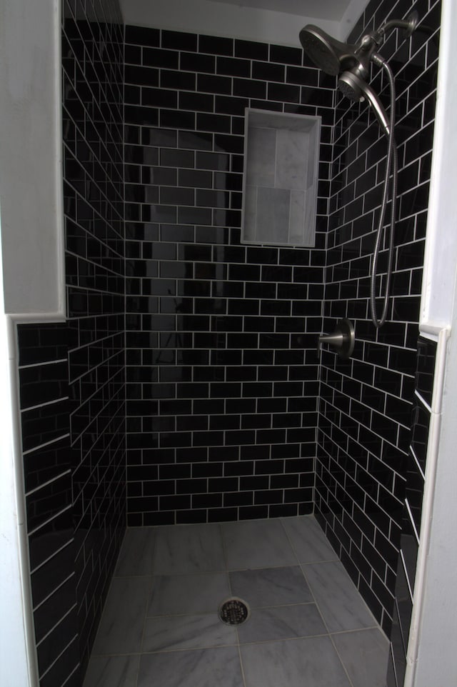 bathroom with tiled shower