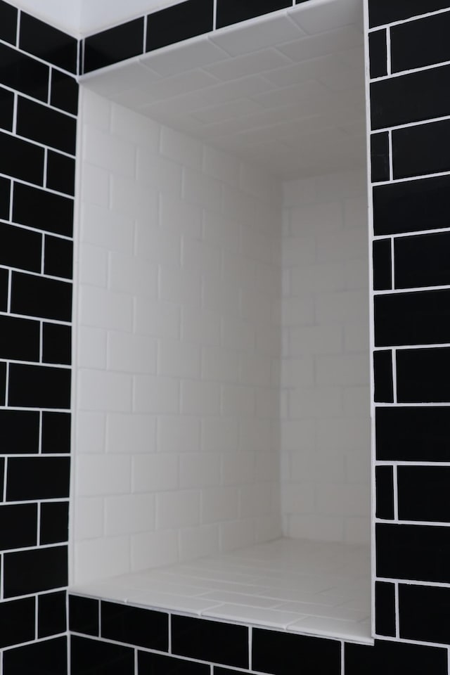 interior space with tiled shower