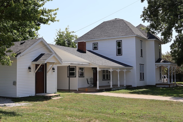 view of property featuring a front yard and covered porch