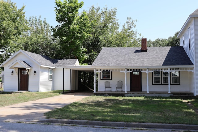 327 E Chestnut St, Bolivar, MO 65613 - view of front facade featuring concrete driveway, a front lawn, a chimney, an attached carport, and a porch