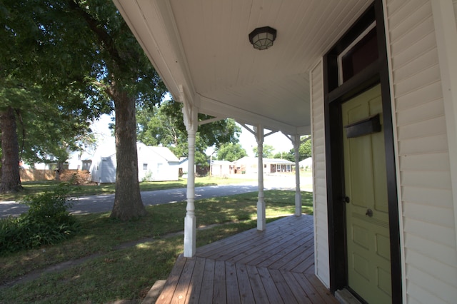 deck with a porch and a lawn