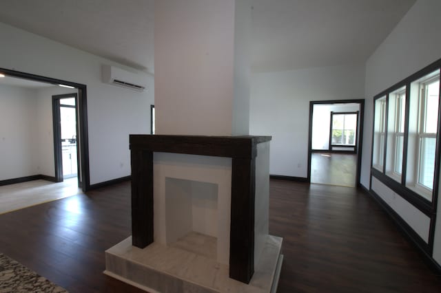 327 E Chestnut St, Bolivar, MO 65613 - unfurnished living room with dark wood finished floors, baseboards, and a wall mounted AC