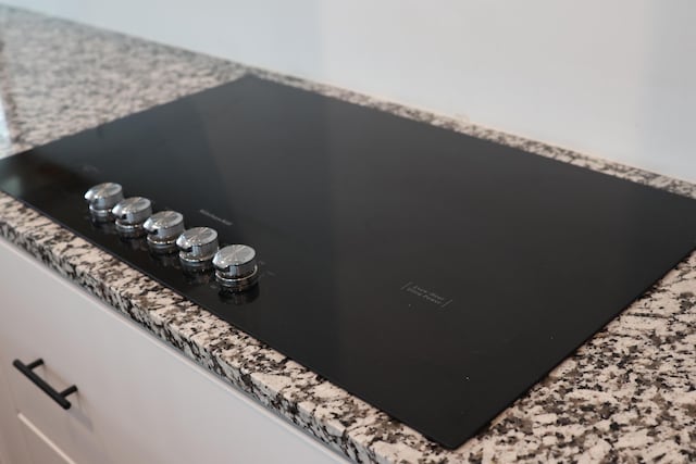 327 E Chestnut St, Bolivar, MO 65613 - interior details featuring black electric cooktop