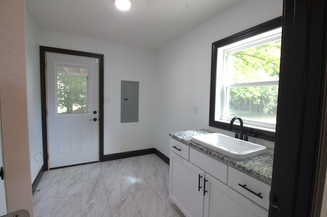 327 E Chestnut St, Bolivar, MO 65613 - clothes washing area featuring electric panel, baseboards, marble finish floor, and a sink