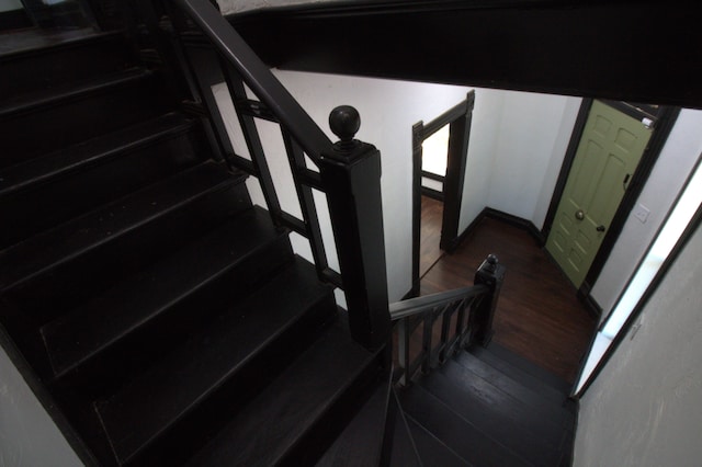 stairs with hardwood / wood-style floors