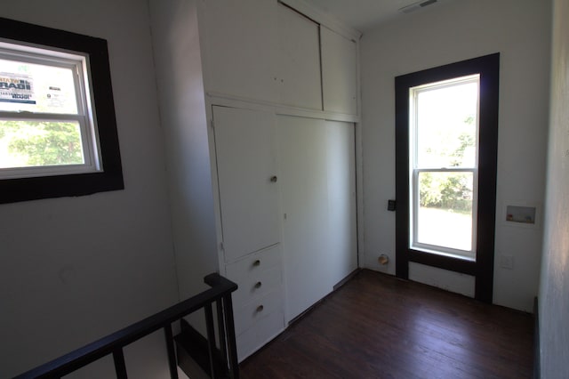 327 E Chestnut St, Bolivar, MO 65613 - doorway to outside with dark wood finished floors and visible vents