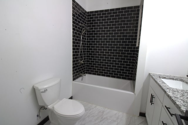 full bathroom featuring vanity, tiled shower / bath combo, and toilet