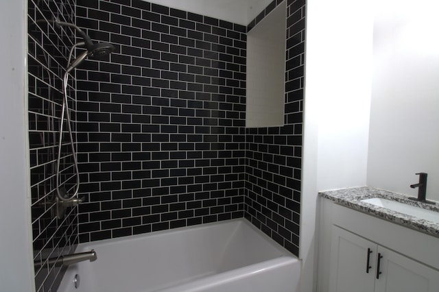 bathroom with vanity and tiled shower / bath combo