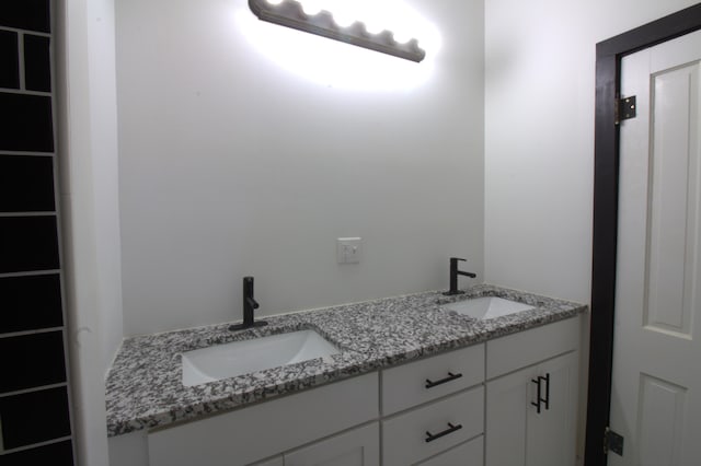 327 E Chestnut St, Bolivar, MO 65613 - bathroom featuring a sink and double vanity