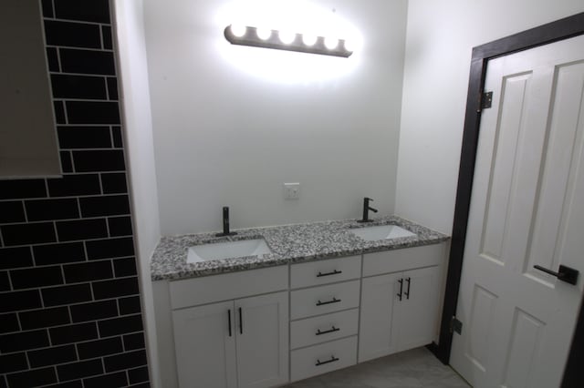 327 E Chestnut St, Bolivar, MO 65613 - full bathroom with double vanity, marble finish floor, and a sink
