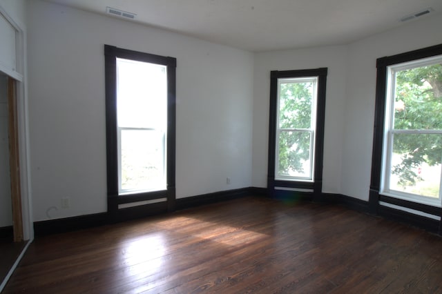 empty room featuring dark hardwood / wood-style flooring