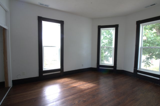 327 E Chestnut St, Bolivar, MO 65613 - spare room with plenty of natural light, visible vents, and dark wood-style flooring
