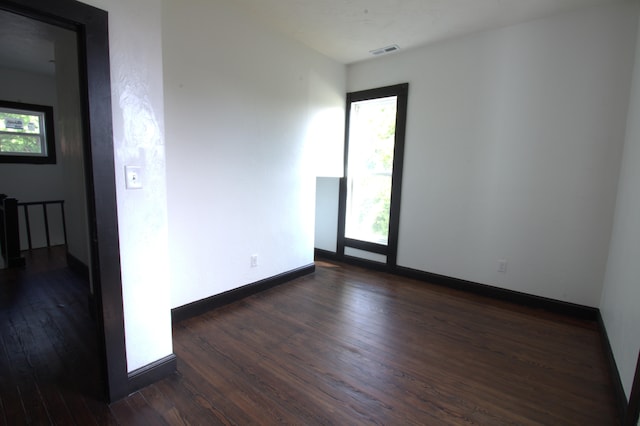 spare room with dark hardwood / wood-style floors