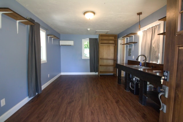 327 E Chestnut St, Bolivar, MO 65613 - kitchen with baseboards, a sink, dark wood finished floors, and a wall mounted air conditioner