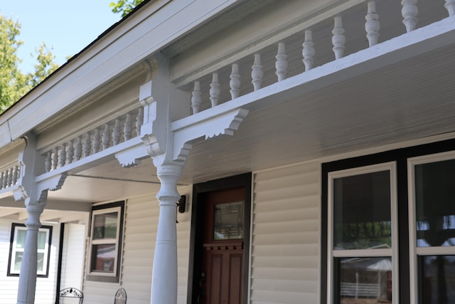 view of side of home featuring covered porch