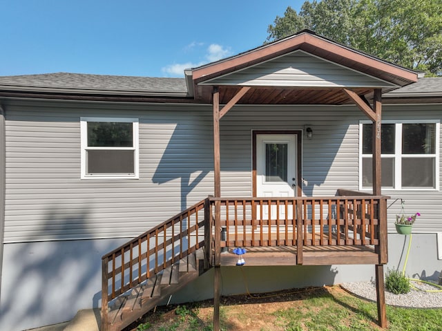 view of exterior entry with a deck