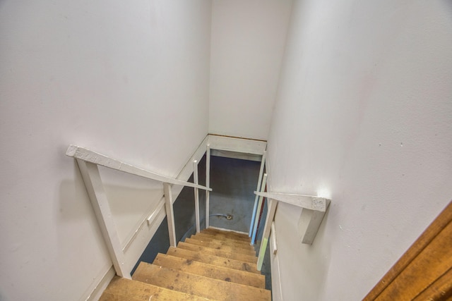 staircase with hardwood / wood-style floors