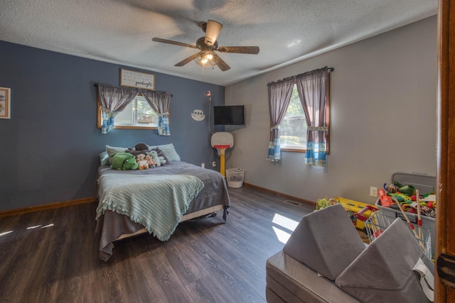 bedroom featuring ceiling fan, a textured ceiling, and dark hardwood / wood-style floors