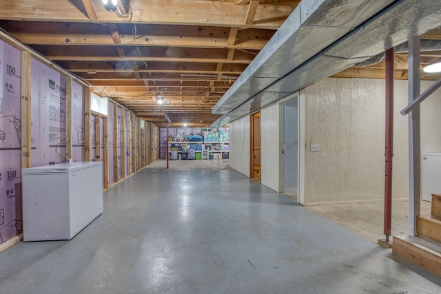 unfinished below grade area featuring refrigerator