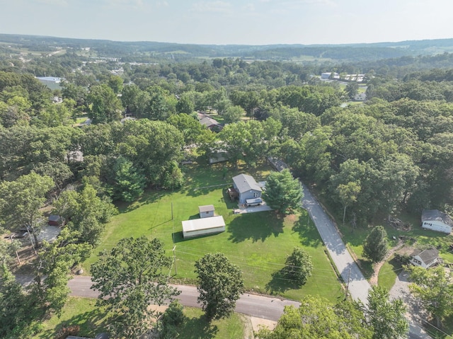 drone / aerial view featuring a wooded view