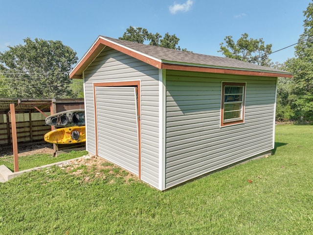 view of outdoor structure with an outbuilding and fence