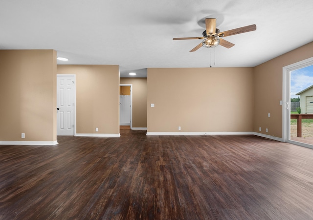 unfurnished living room featuring dark wood-type flooring and ceiling fan