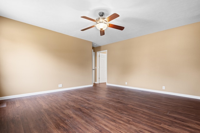 empty room featuring ceiling fan and dark hardwood / wood-style flooring