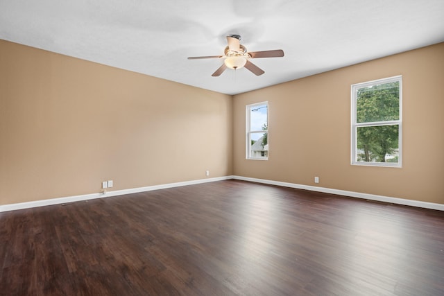 unfurnished room featuring ceiling fan, plenty of natural light, and dark hardwood / wood-style floors