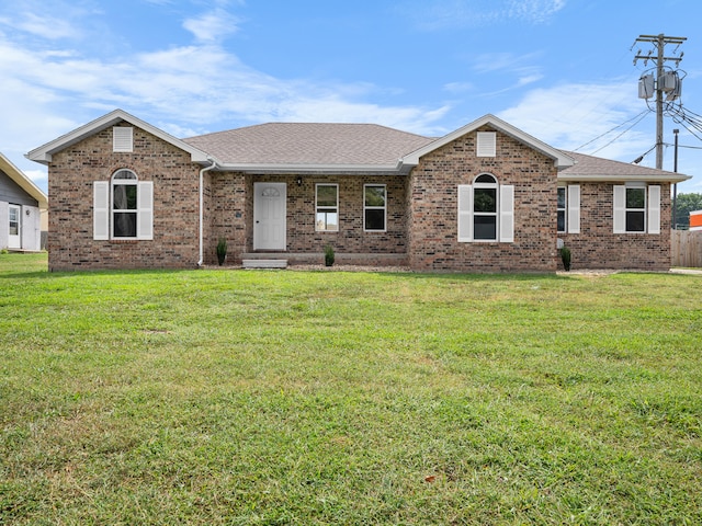 702 E Buffalo St, Bolivar, MO 65613 - ranch-style house featuring a shingled roof, a front lawn, and brick siding