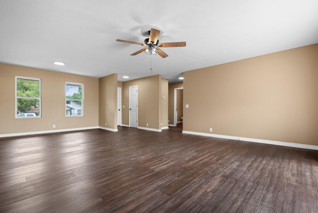 empty room featuring ceiling fan and dark hardwood / wood-style flooring