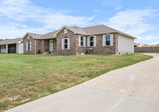 702 E Buffalo St, Bolivar, MO 65613 - single story home with roof with shingles, driveway, fence, brick siding, and a front yard